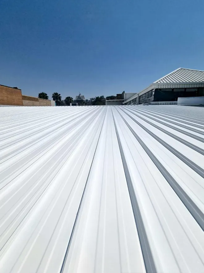 Cool roofing sur toiture d'entrepôt : peinture blanche réflective anti-chaleur